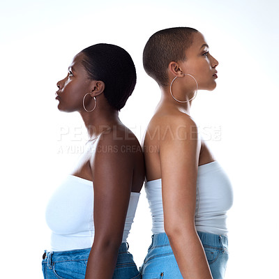 Buy stock photo Portrait of two beautiful women standing back to against a white background