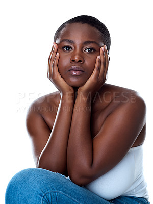 Buy stock photo Portrait of a beautiful young woman touching her face while standing against a white background