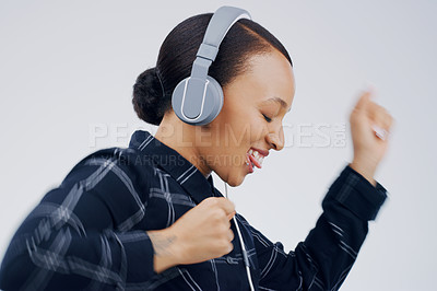 Buy stock photo Studio shot of an attractive young woman dancing against a grey background