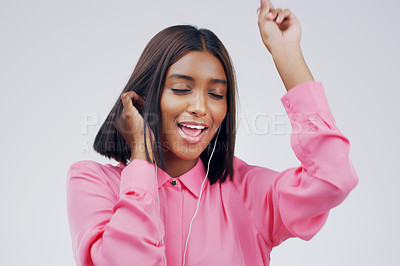 Buy stock photo Earphones, dancing or Indian woman streaming music in studio for singing on grey background. Smile, relax or happy person listening to radio playlist, sound or song audio on an online subscription