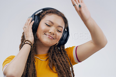 Buy stock photo Woman, studio or dance with headphones in zoom for music, streaming or listening with happiness. Female student or celebrate on backdrop with audio for diploma, happy with interest for study loan