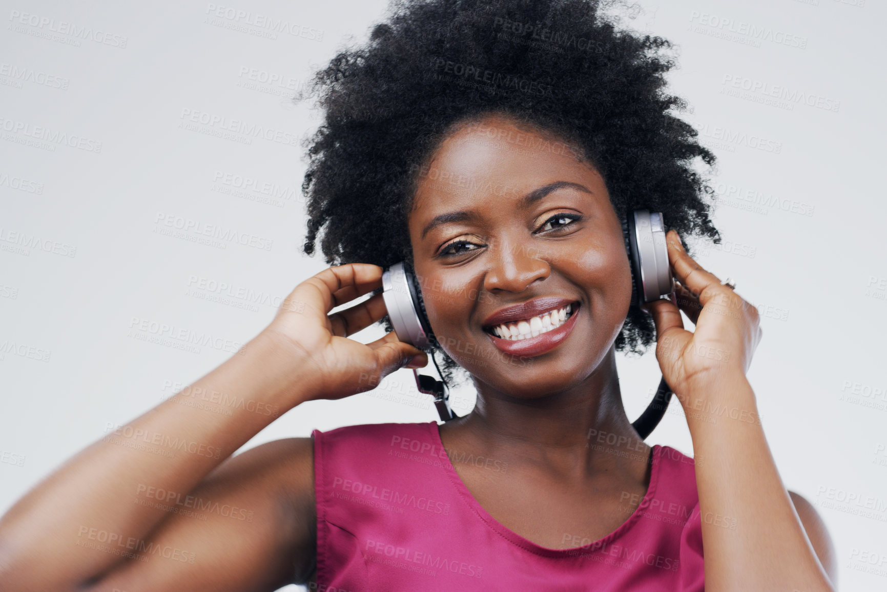Buy stock photo Portrait, music or happy black woman in headphones in studio for singing on grey background. Model, face or African person listening to radio playlist, sound or podcast audio with smile, joy or afro