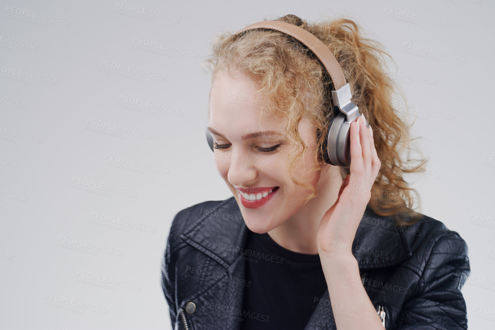 Buy stock photo Relax, music or happy woman in headphones in studio for singing or streaming on grey background. Mockup space, face or girl listening to radio playlist, sound or podcast audio subscription with smile