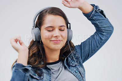 Buy stock photo Headphones, dance or woman streaming music in studio for wellness on grey background to relax. Model, podcast or calm girl listening to radio playlist, sound or song audio on an online subscription