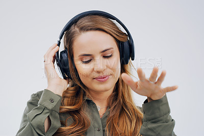 Buy stock photo Woman, studio or celebrate with headphones in closeup for music, streaming or listening with happiness. Female student or dance on backdrop with audio for diploma, happy with interest for study loan