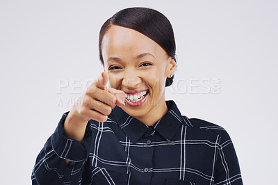 Buy stock photo Portrait of a beautiful young woman pointing to the camera against a grey background