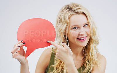 Buy stock photo Woman, happy and pointing in studio with speech bubble, comment or idea for promotion and advertising. Opinion, faq and quote for product placement, answer for conversation on white background