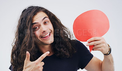 Buy stock photo Man, speech bubble and point in studio portrait with smile, opinion or social media by white background. Gen z guy, poster or paper sign for vote, review and mockup with promo for ideas, news or chat