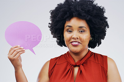 Buy stock photo Portrait of an attractive young woman holding a speech bubble against a grey background