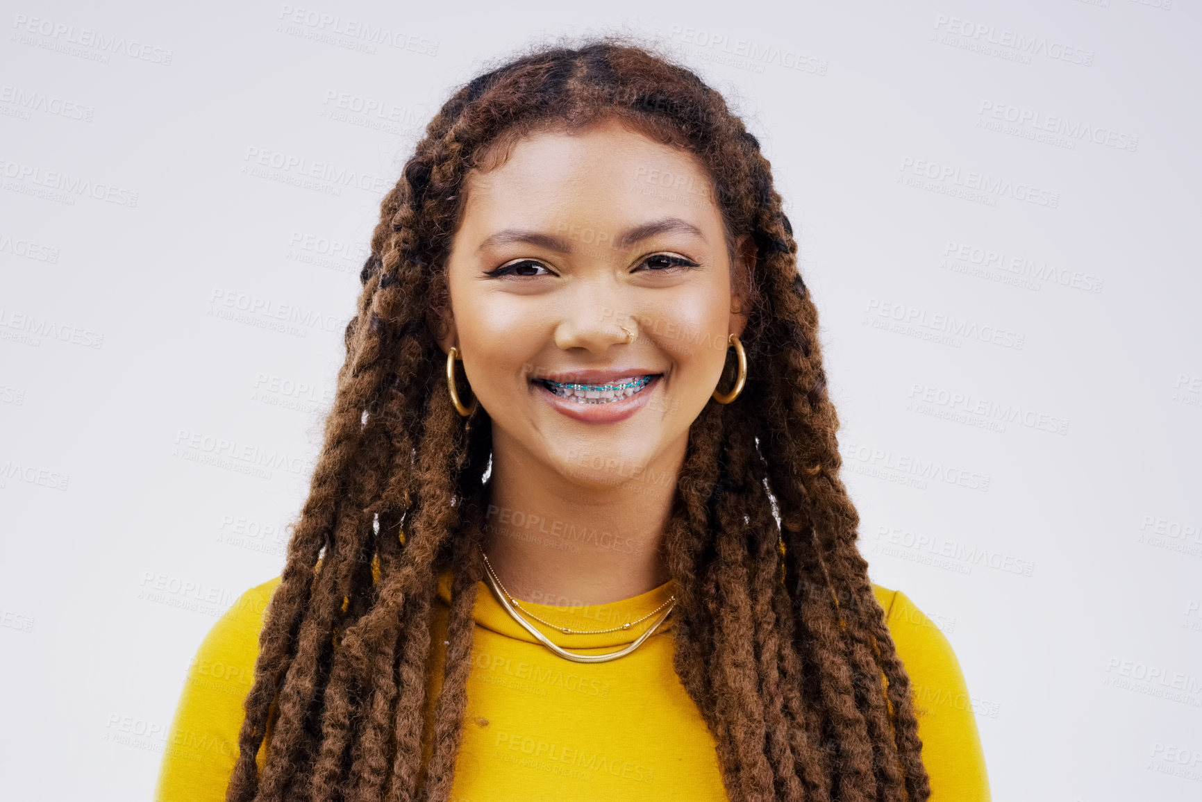 Buy stock photo Happy, smile and portrait of a woman with braces isolated on a white background in a studio. Happiness, confident and a face headshot of a young girl with dreadlocks, confidence and positivity