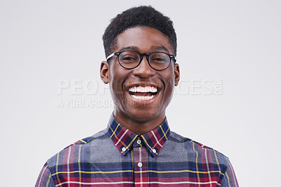 Buy stock photo Studio portrait of a handsome young man laughing against a grey background