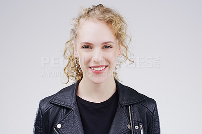 Buy stock photo Studio portrait of an attractive young woman smiling against a grey background