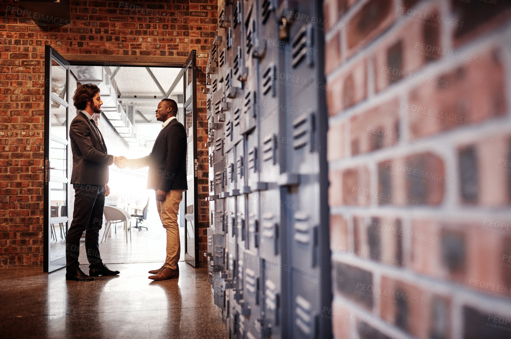 Buy stock photo Businessman, handshake and welcome with partnership for agreement, deal or teamwork in corridor at office. Business people, colleagues or coworkers shaking hands for b2b, greeting or introduction