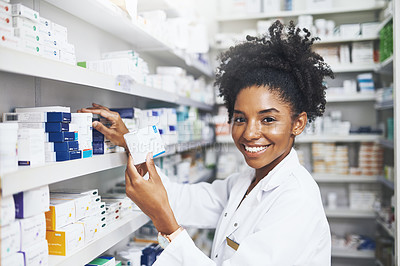 Buy stock photo Cropped shot of a female pharmacist taking a product from the shelves