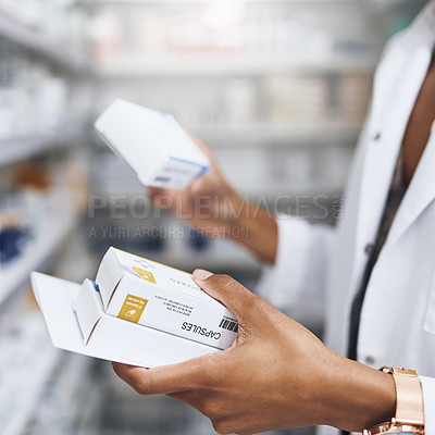 Buy stock photo Cropped shot of a pharmacist filling a prescription at a chemist