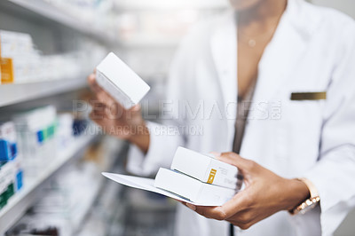 Buy stock photo Cropped shot of a pharmacist filling a prescription at a chemist