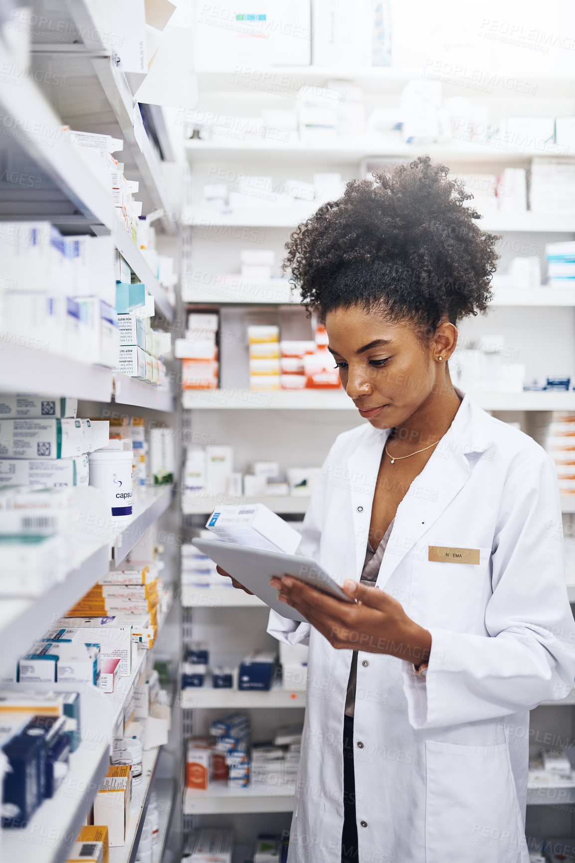 Buy stock photo Black woman, tablet and check stock at pharmacy for medicine, inventory and reading product label. Tech, pharmacist and medical worker with drugs for online prescription order or health information