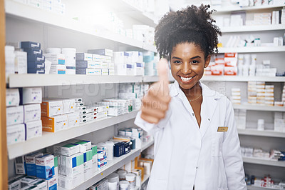 Buy stock photo Portrait of a confident young pharmacist showing thumbs up in a chemist