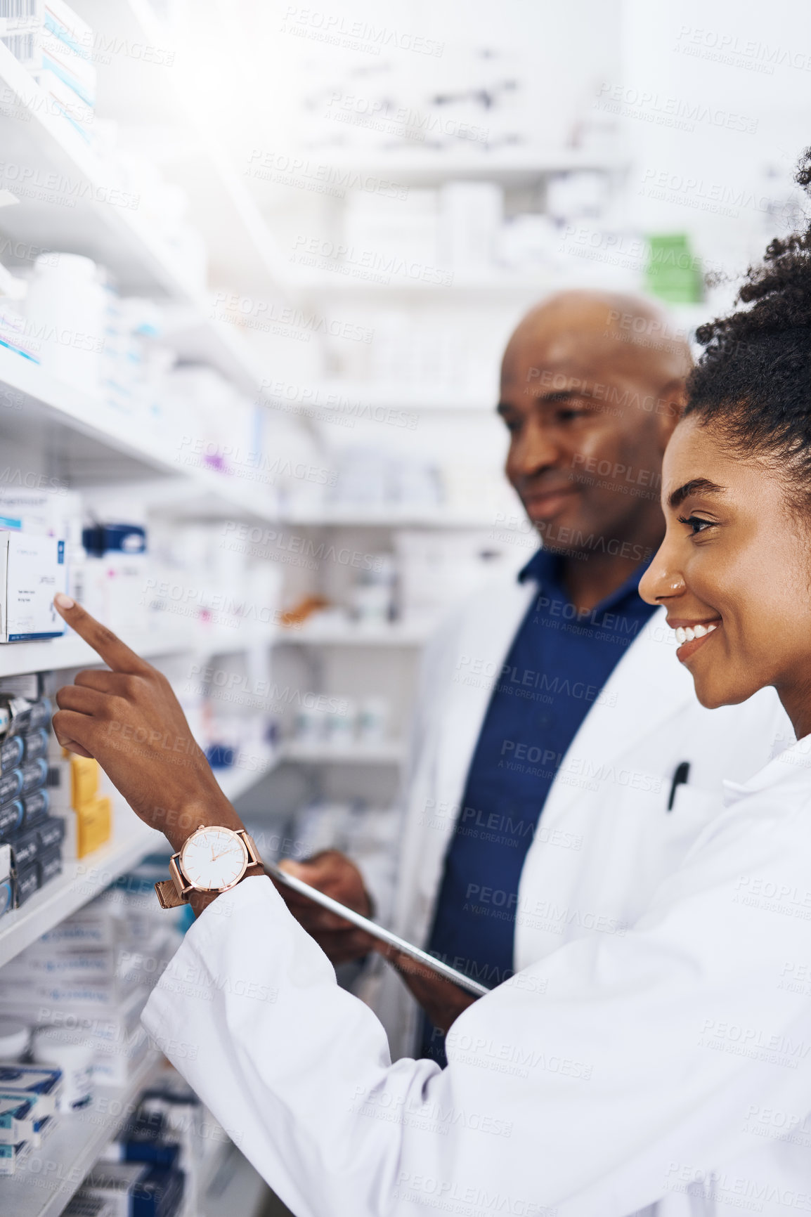 Buy stock photo Shot of two pharmacists doing inventory in a pharmacy with a digital tablet