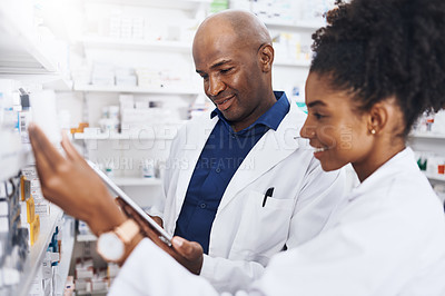 Buy stock photo Healthcare, pharmacist and black people or tablet in clinic of medicine stock, reading and check for label information. Woman, man and digital Telehealth for medical inventory, inspection and retail
