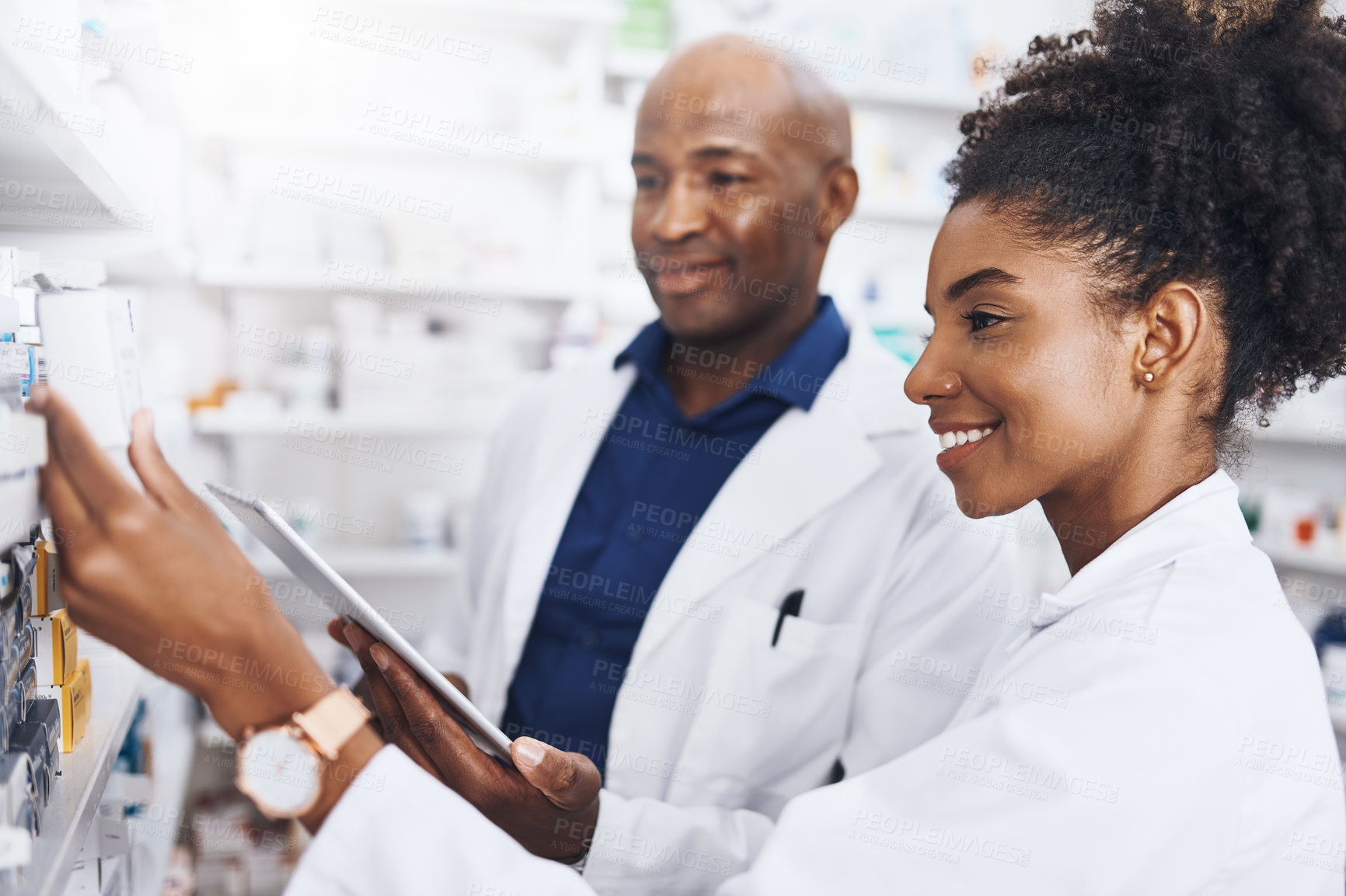 Buy stock photo Healthcare, tablet and pharmacist as black people in clinic of medicine stock, reading and check for label information. Woman, man and digital Telehealth for medical inventory, inspection and retail