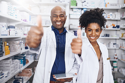 Buy stock photo Cropped shot of two pharmacists showing thumbs up