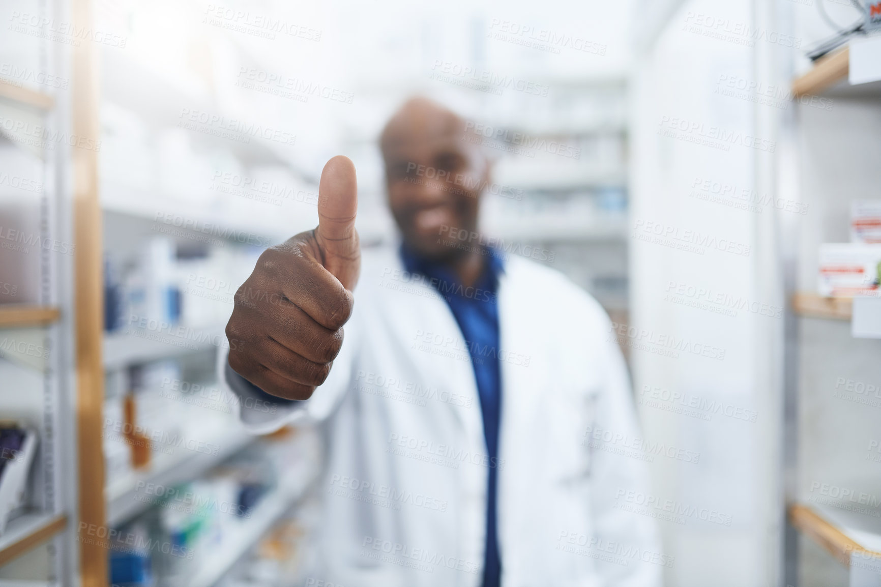 Buy stock photo Shot of a confident pharmacist showing thumbs up in a chemist