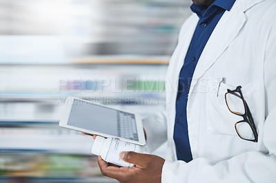 Buy stock photo Cropped shot of a pharmacist using a digital tablet in a chemist
