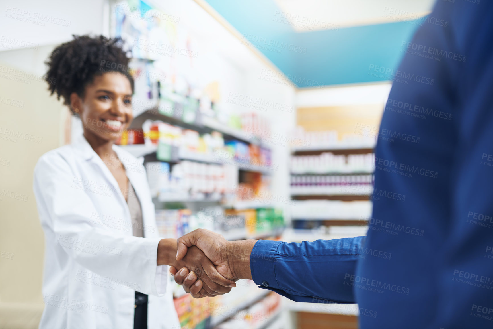 Buy stock photo Cropped shot of a pharmacist and a customer shaking hands