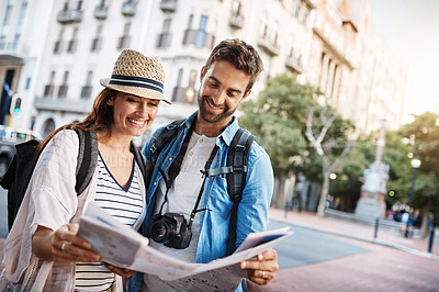 Buy stock photo Couple, tourist and a map in a city for travel on a street for direction or location search. Man and woman together with paper for navigation outdoor on urban road for adventure, journey or vacation