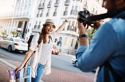 Buy stock photo Cropped shot of an attractive woman posing for a picture while out in a foreign city with her husband