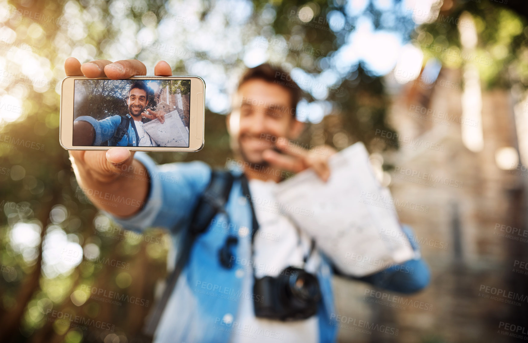 Buy stock photo Man, phone screen and travel selfie outdoor in a city with holiday memory, smile and peace sign. Male person outdoor for adventure, journey or vacation photo and freedom with hand for emoji or icon