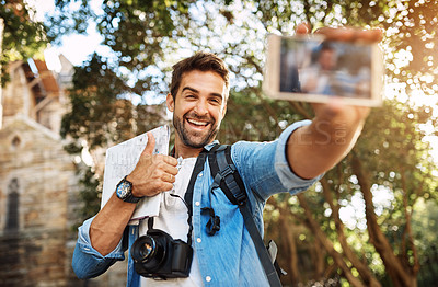 Buy stock photo Happy man, tourist and thumbs up selfie outdoor in a city for travel with holiday memory, smile and happiness. Male person on adventure, journey with sign for vacation photo and freedom with backpack