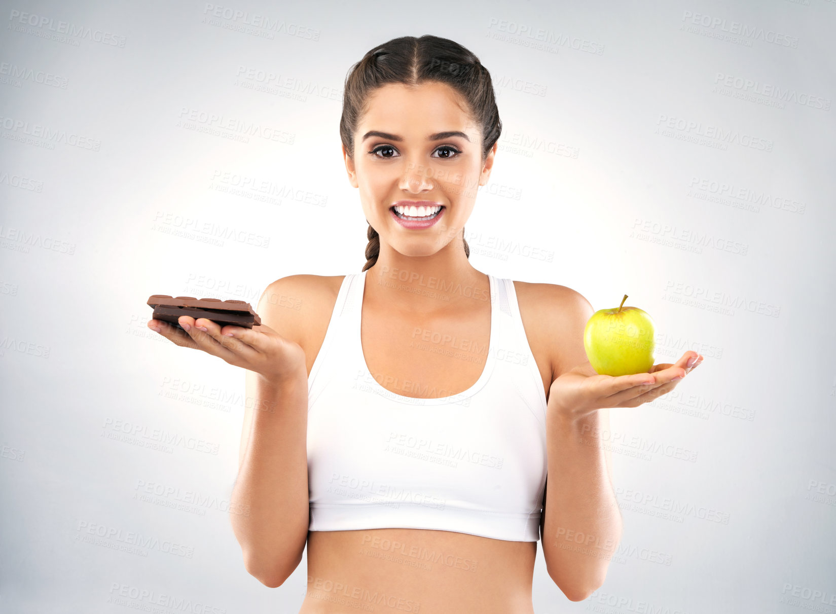 Buy stock photo Woman, choice and portrait in studio for diet, chocolate and apple for nutrition on white background. Wellness, vitamin c and weight loss for female person, natural and organic for food and health