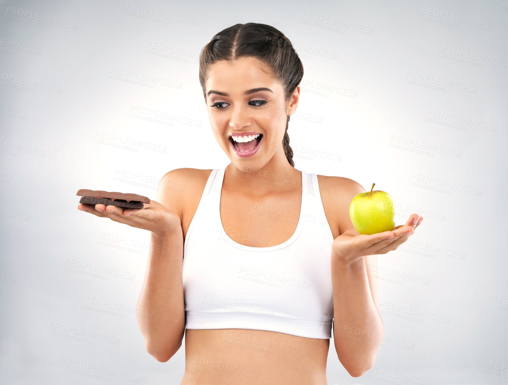 Buy stock photo Woman, choice and chocolate in studio for diet, face and apple for nutrition on white background. Wellness, vitamin c and weight loss for female person, natural and organic for food and health