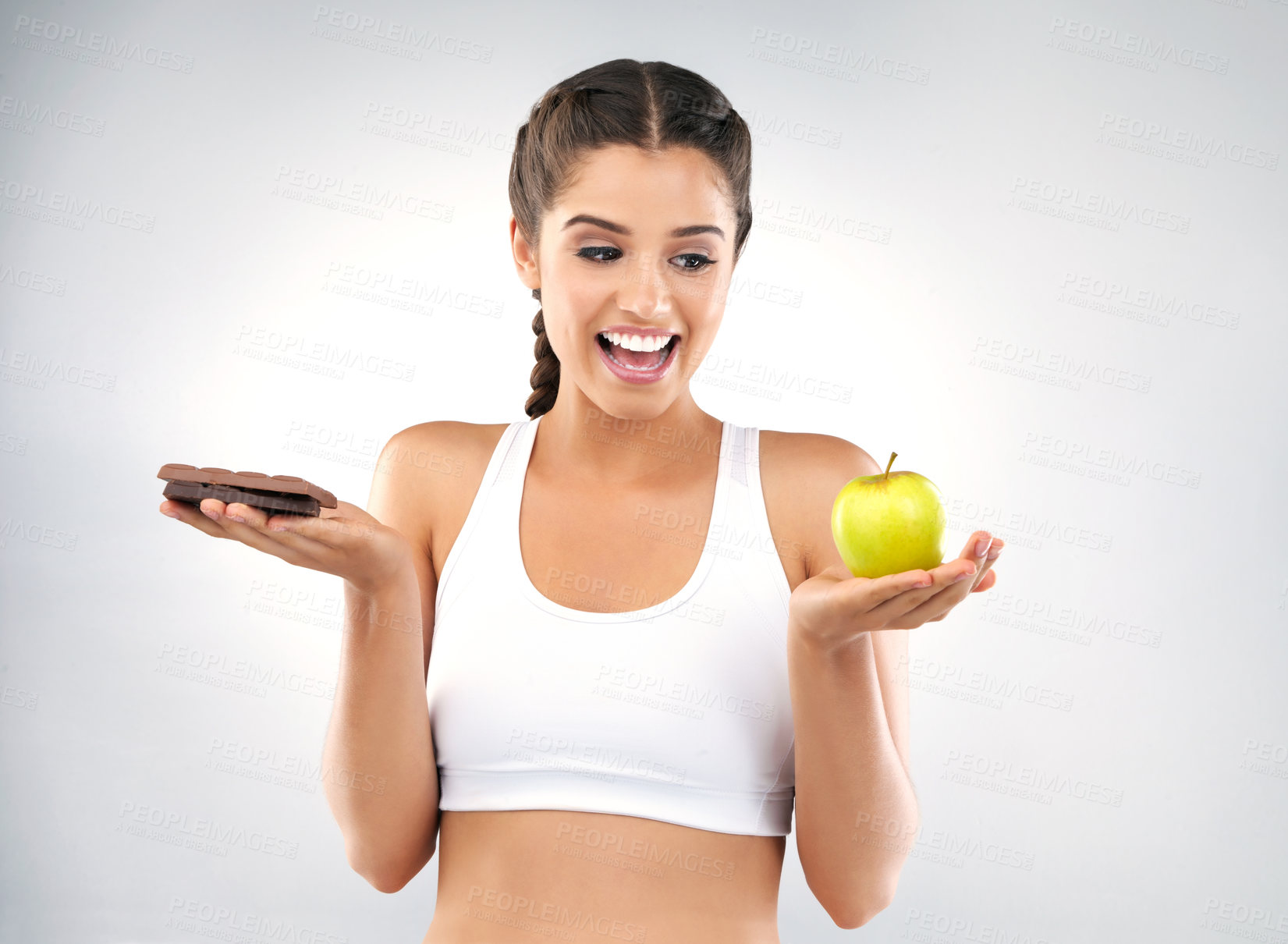 Buy stock photo Woman, choice and apple in studio for diet, face and chocolate for nutrition on white background. Wellness, vitamin c and weight loss for female person, natural and organic for food and health detox