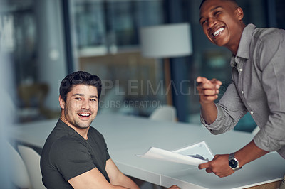 Buy stock photo Shot of two young businessmen having a meeting in a modern office