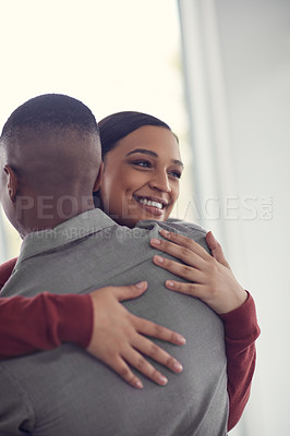 Buy stock photo Shot of a happy young couple hugging each other