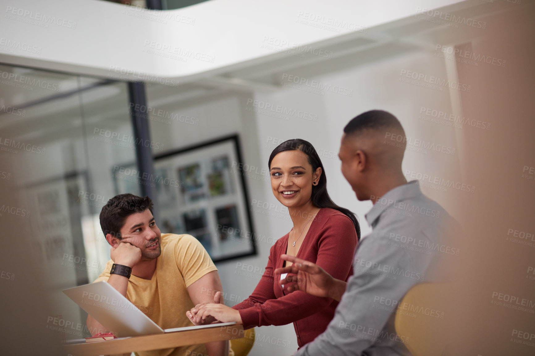 Buy stock photo Shot of a group of young businesspeople having a meeting in a modern office