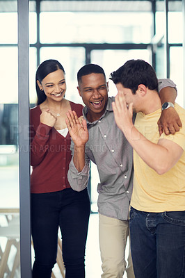 Buy stock photo Shot of a group of young businesspeople celebrating in a modern office