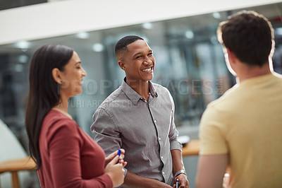 Buy stock photo Shot of a group of young businesspeople having a discussion in a modern office