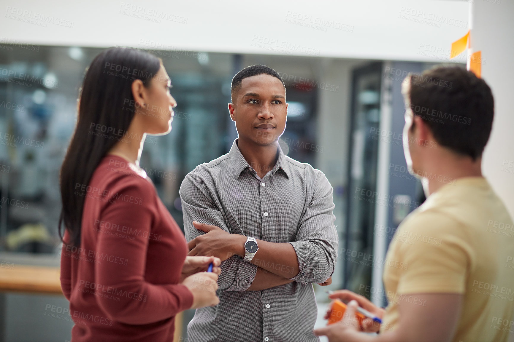 Buy stock photo Shot of a group of young businesspeople having a brainstorming session in a modern office