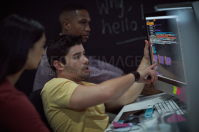 Buy stock photo Shot of a group of young businesspeople working on a computer network during a late night at work