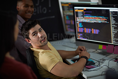 Buy stock photo Shot of a group of young businesspeople working on a computer network during a late night at work