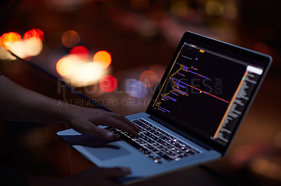 Buy stock photo Shot of an unrecognisable hacker using a laptop in the dark