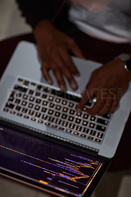 Buy stock photo Shot of an unrecognisable hacker using a laptop