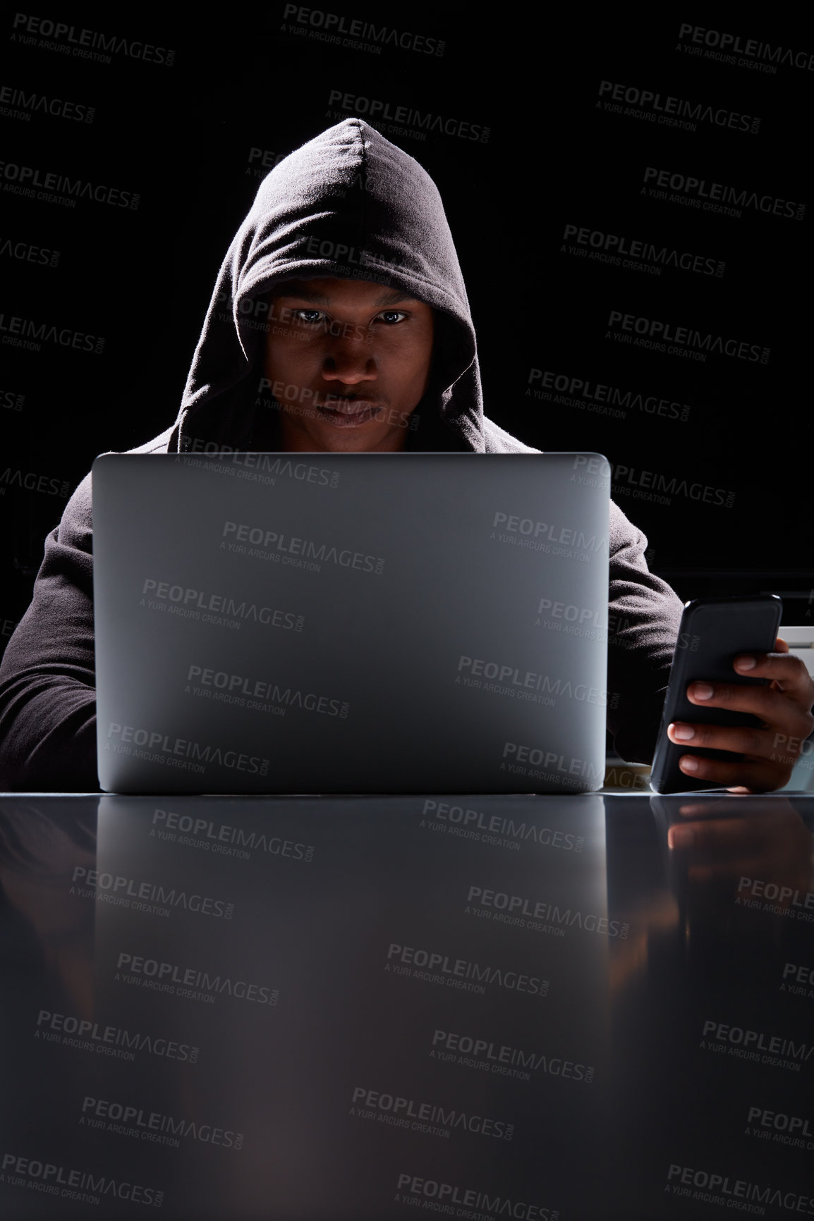 Buy stock photo Shot of a young hacker using a laptop