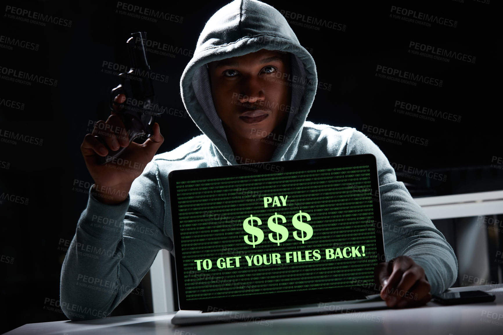 Buy stock photo Shot of an armed hacker using a laptop with “Pay $$$ to get your files back” on it