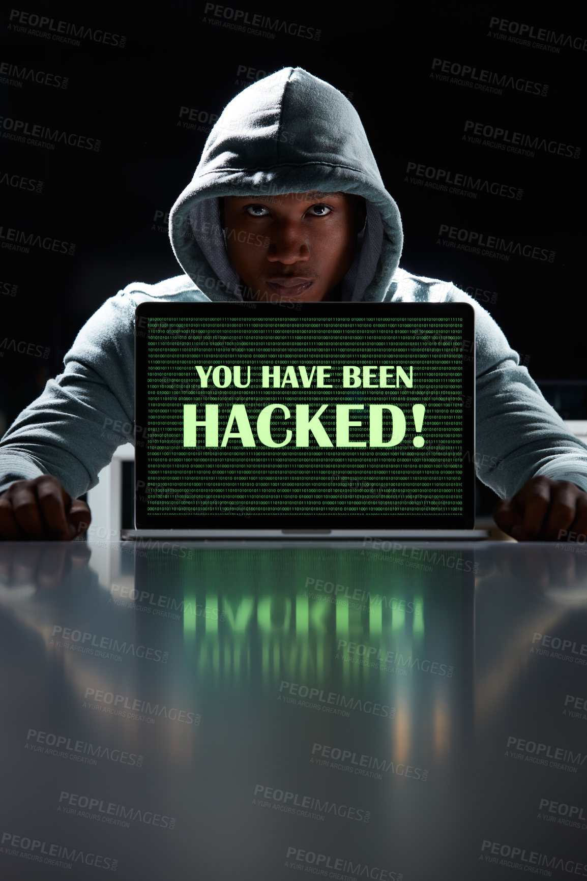 Buy stock photo Shot of a young hacker using a laptop with the words “You have been hacked” on it
