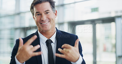 Buy stock photo Cropped shot of a mature businessman showing a shaka hand sign while walking through a modern office